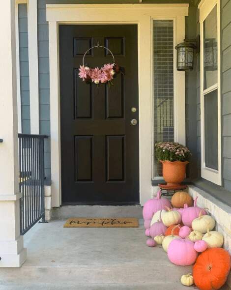 pink fall decor outdoors wreath and pumpkins