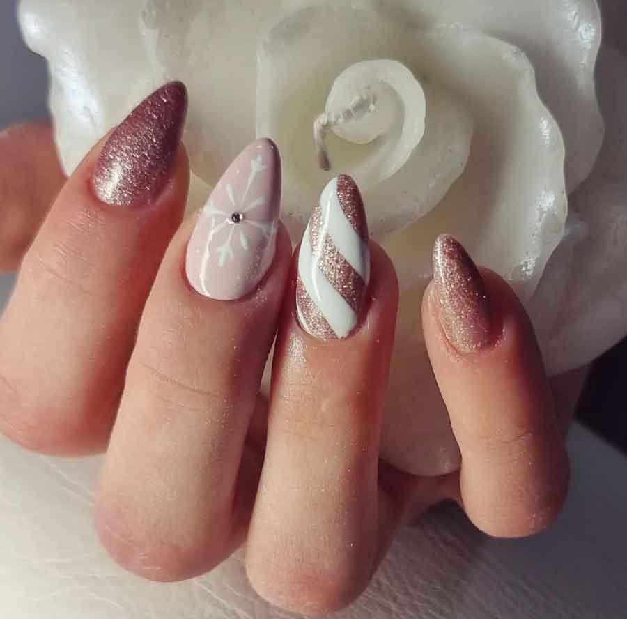 rose gold and white snowflake flitter almond christmas nails
