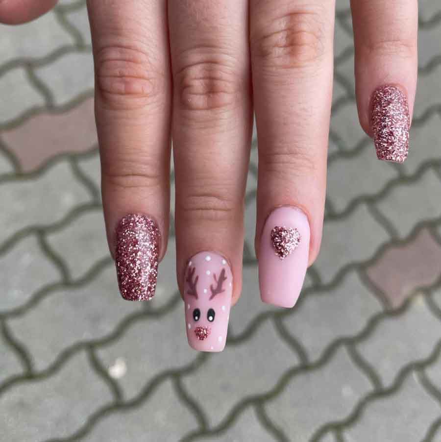 rose gold and pink reindeer christmas nail design