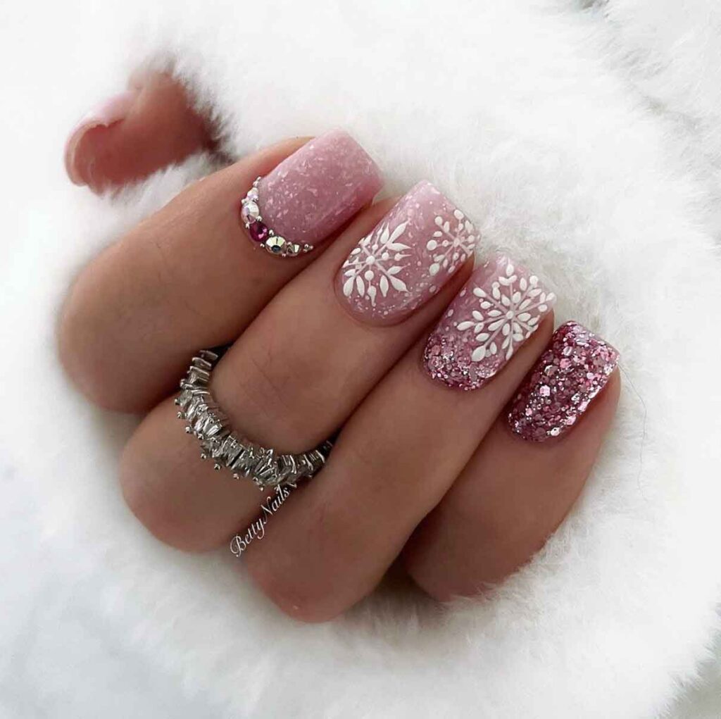 rose gold winter wonderland nails with gems and snowflakes