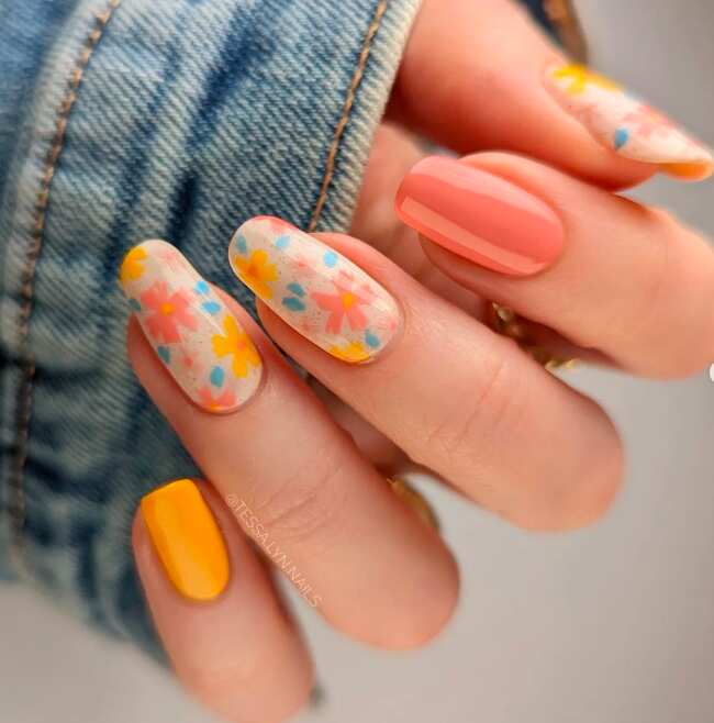 long oval nails with coral and yellow sprig flower nail design