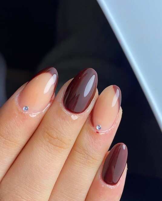 dark brown oval nails with Tiny rhinestones