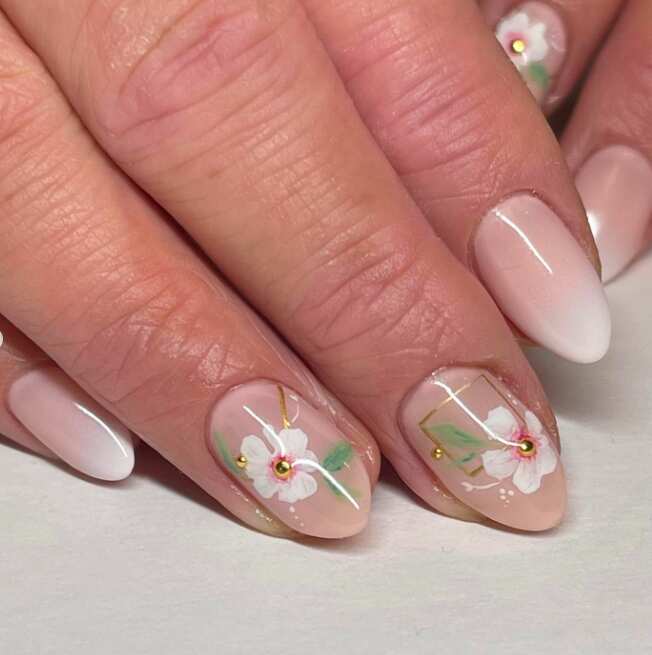short almond nails with painting white flower art and gold accents