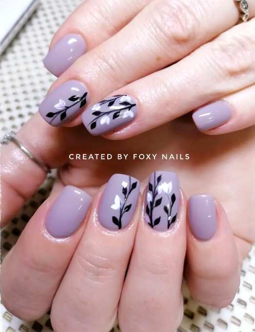 square nails with purple and black floral art