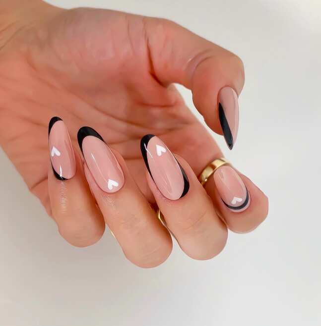 A minimalist chic black white and nude nail design with heart for valentines day