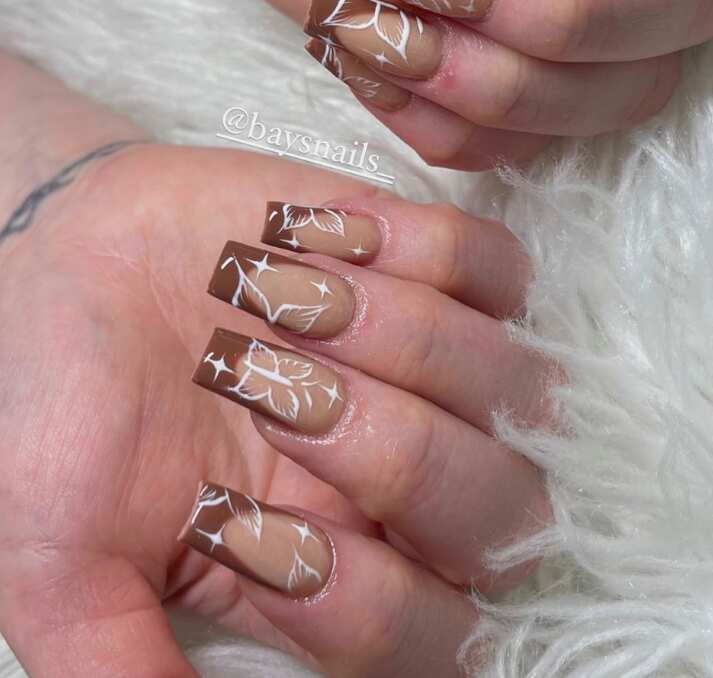 long square light brown nails with white butterfly art