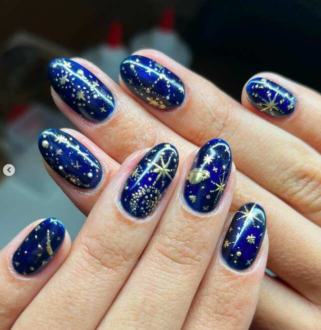 navy blue nails with Gold Constellation Design