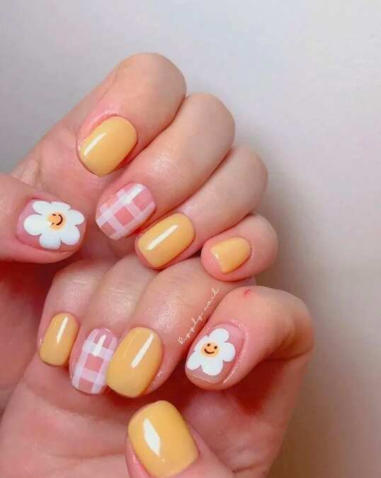 short nails with white checkered and yellow flower design