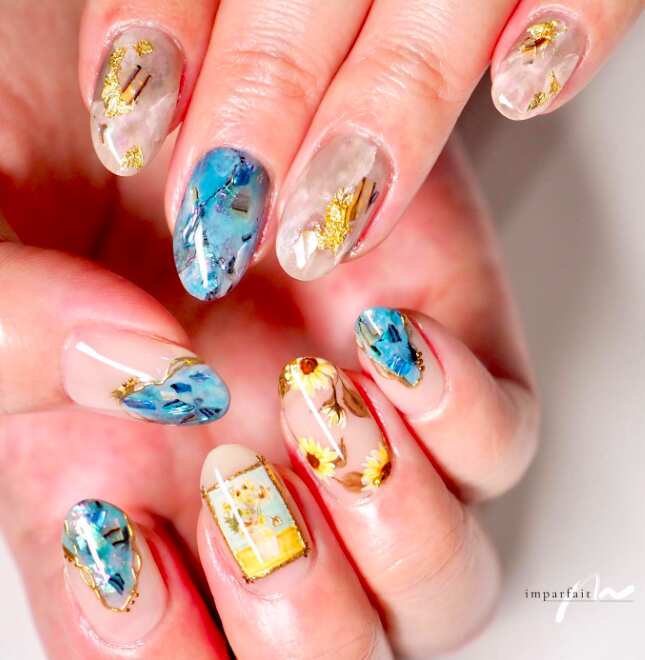 oval nails with artistic blue yellow and gold sunflower art
