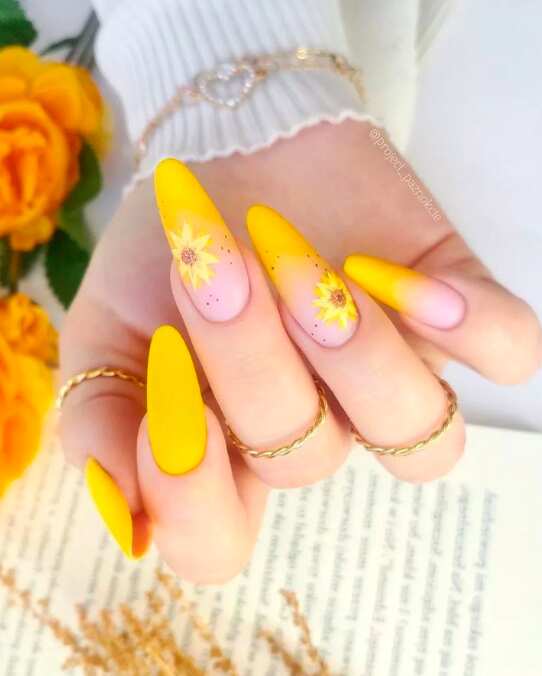 long oval nails with bright yellow sunflower design