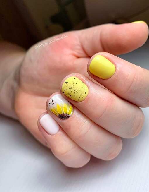 short nails with yellow sunflower and speckled easter egg art design