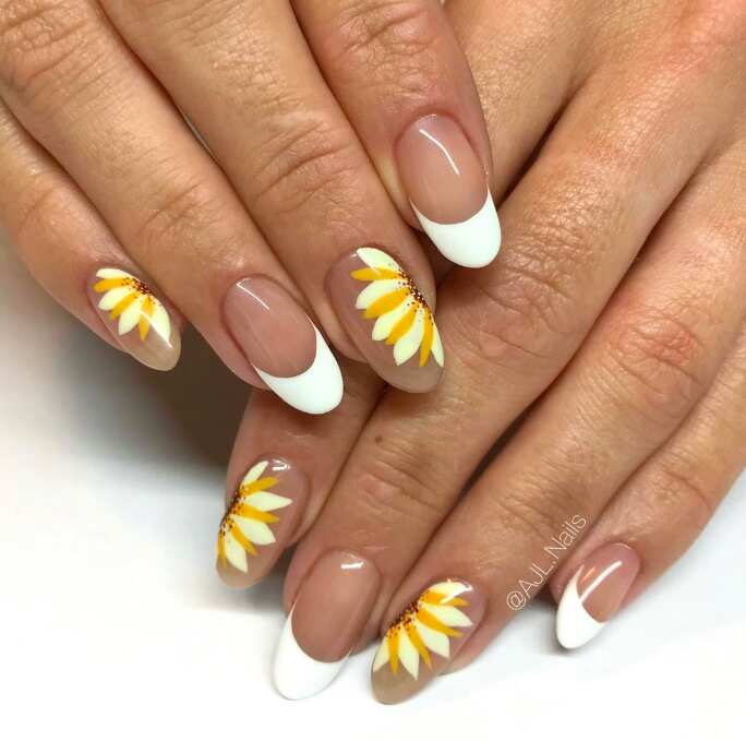 oval nails with white french tips and half sunflowers design