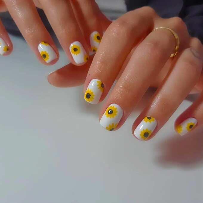 short square nails with white nail polish and yellow sunflowers art design