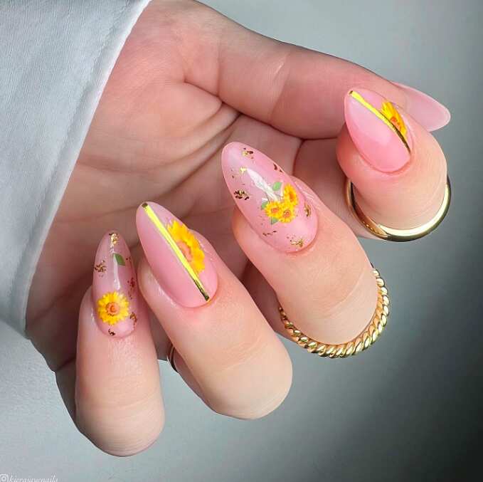 long oval nails with sunflower gold design