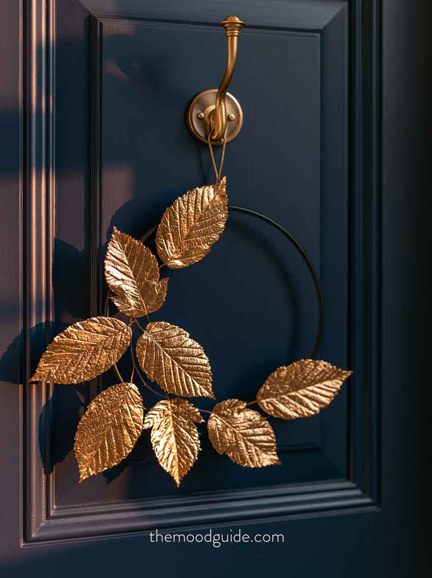 elegant gold fall wreath on navy blue door