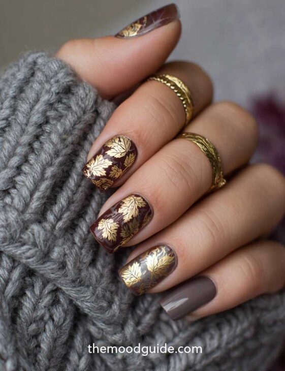 dark brown fall nail with gold maple leaf design