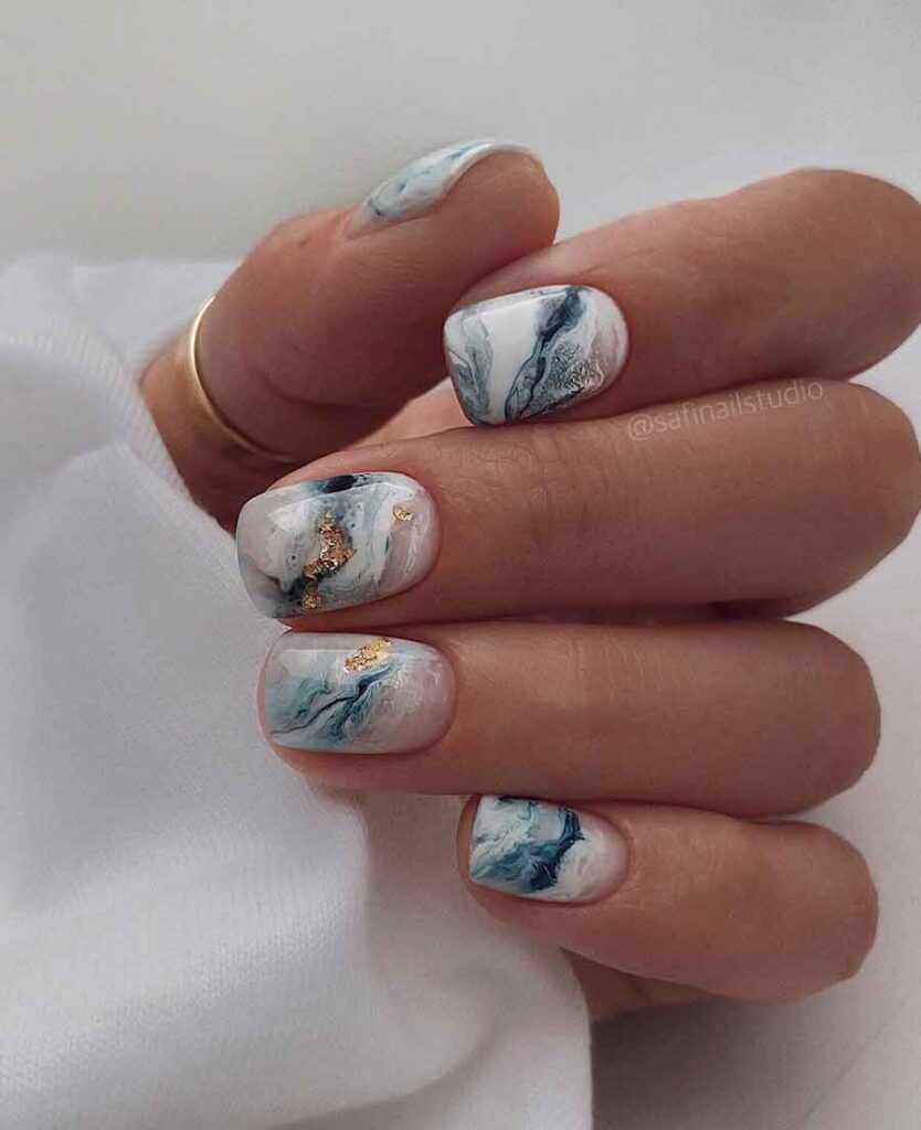 white and blue marble nails