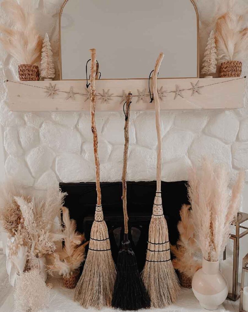 witchy christmas living room decor with brooms aesthetic
