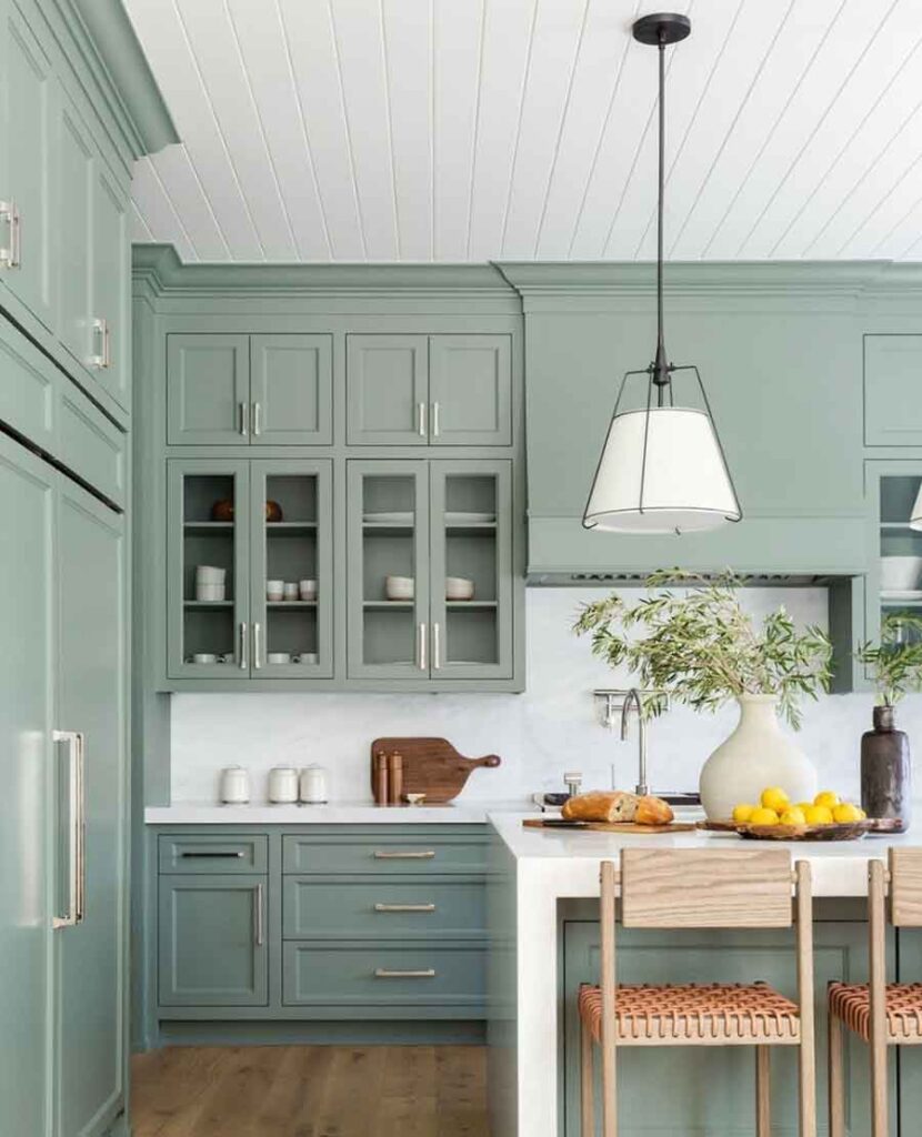 sage green kitchen cabinets with white marble countertop