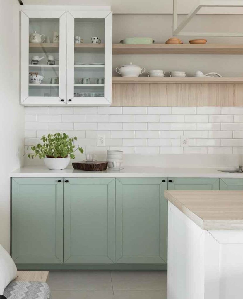 sage green kitchen cabinets with white countertops and white subway tiles