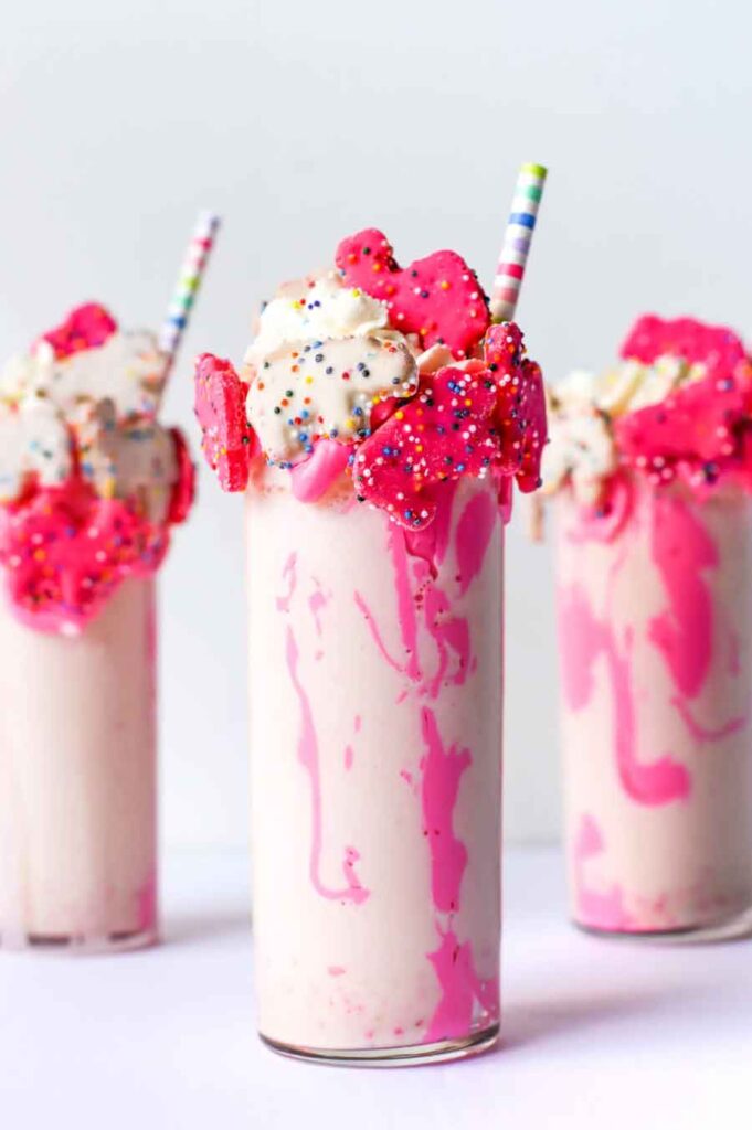 pink frosting aesthetic vanilla milkshake topped with rainbow sprinkles recipe for barbie and barbiecore party treats