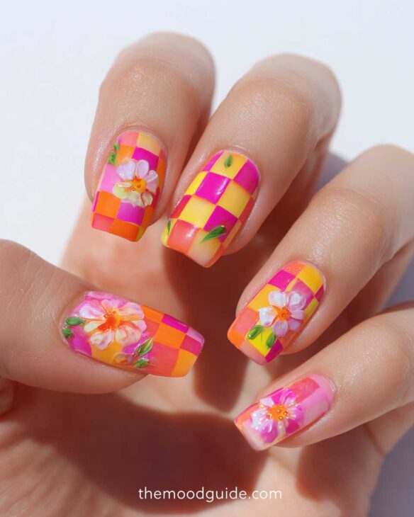 square fingernail design with checkered neon nail polish in yellow orange and pink and flowers