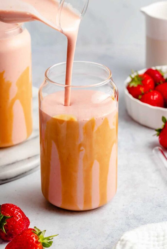 a refreshing pink aesthetic strawberry  banana smoothie with peanut butter recipe