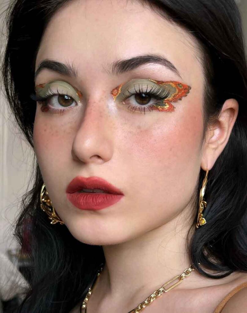 orange and green fall fairy makeup with butterfly wing