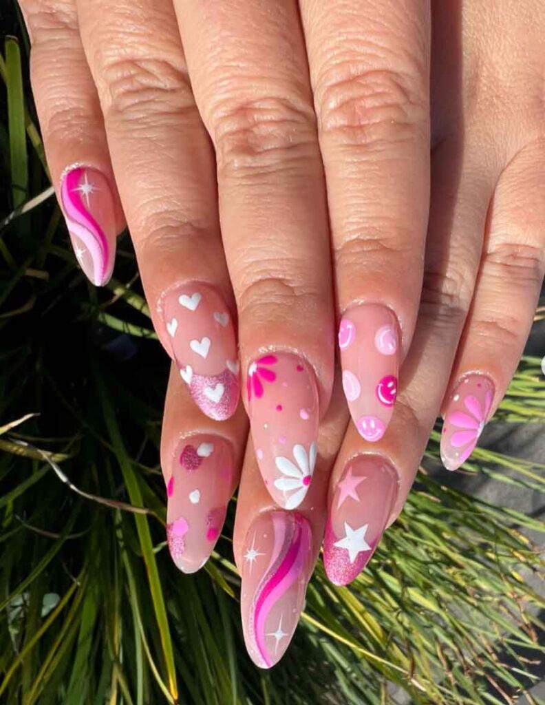 Pink and white flower design on nails with pink nail tip with glitter