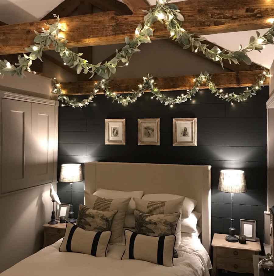 christmas decor in bedroom with garlands and fairy lights