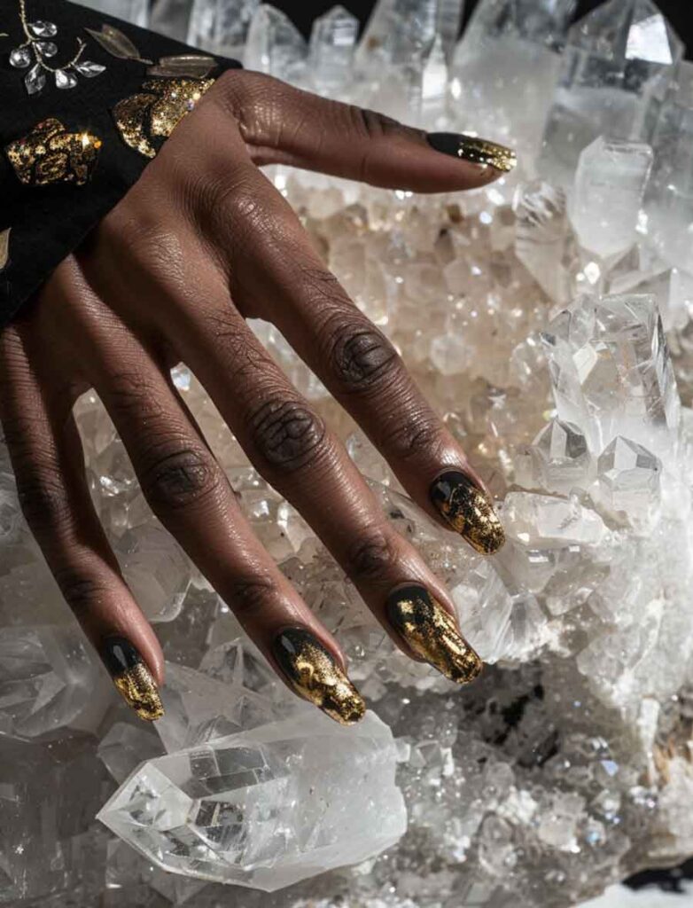 luxury aesthetic manicure on black hands wearing black and gold foil nail art