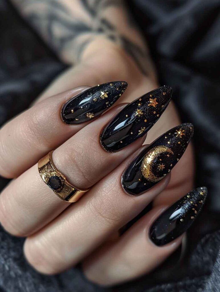 black and gold witchy celestial nails with moon and stars