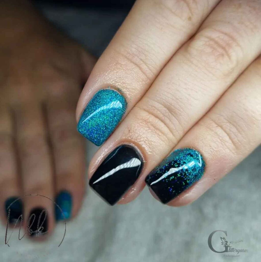 black and teal nails with glitter