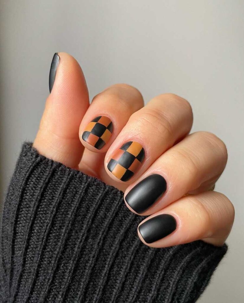 dark academia nail art with checkered black and brown design on short nails