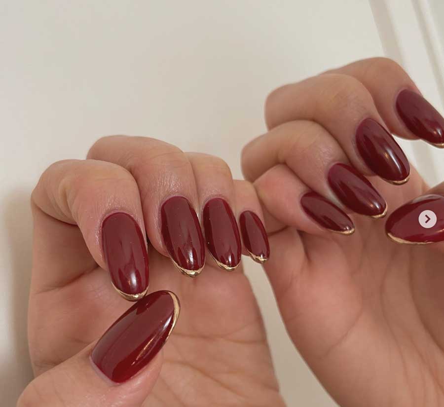 dark red with gold nails for fall or vampire academia aesthetic