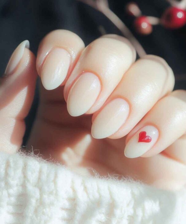 milky white minimalist nails for valentines day with cute red little heart design.