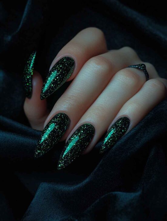 stiletto with glittery gold slytherin nails shimmering