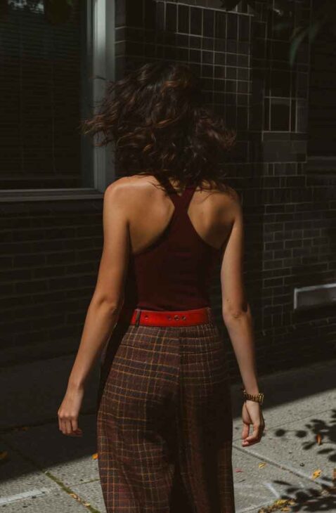 spring dark academia outfit styled with plaid pants and burgundy tank and red belt