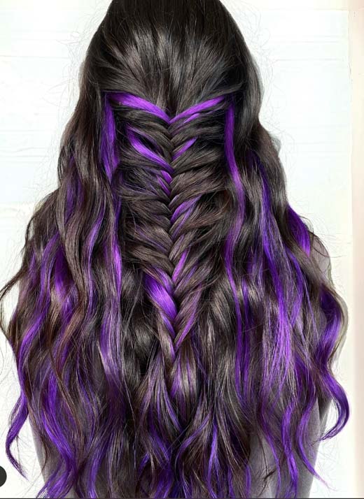 purple highlights on black brunette hair with braid. witchy hair