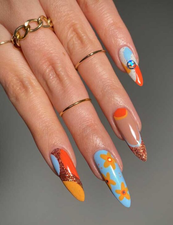 long blue and orange summer nails with glitter and flowers