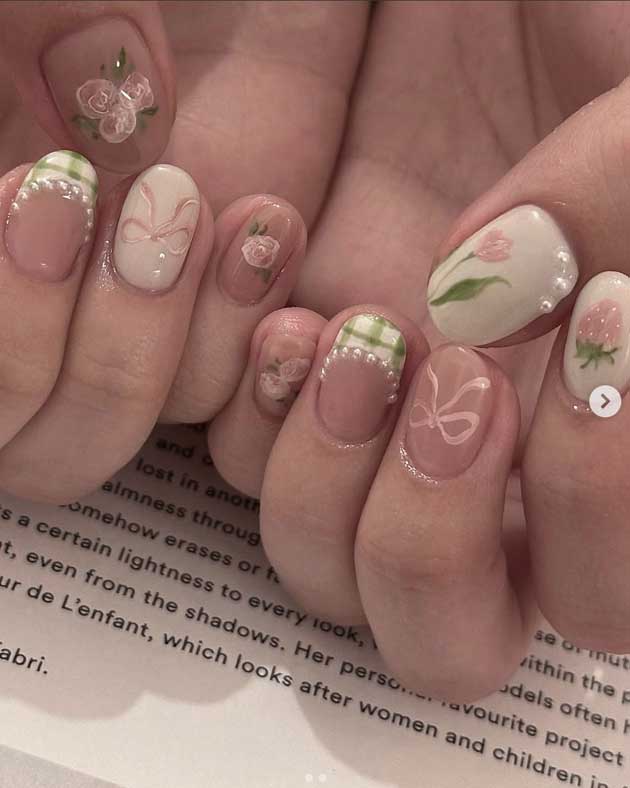 pink and green spring coquette nails with handrawn bows and roses and pearls and tulips art