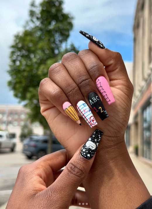 School-themed nail art on the entire coffin shape nails for baddie aesthetic on black woman hands