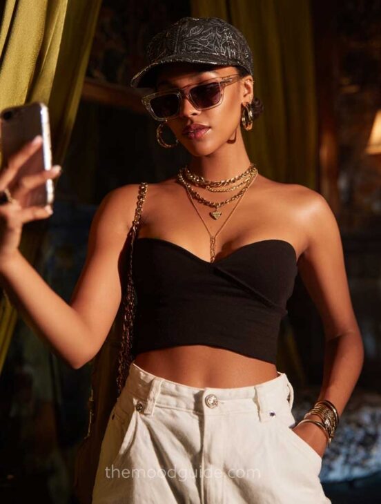 short baddie hairstyle with cap and gold accessories