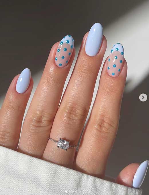 baby blue back to scholl nails on almond nails with polka dots and french tips