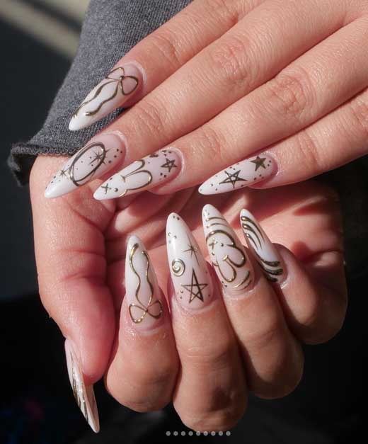 white nails with gold doodles for elegant back to school manicure