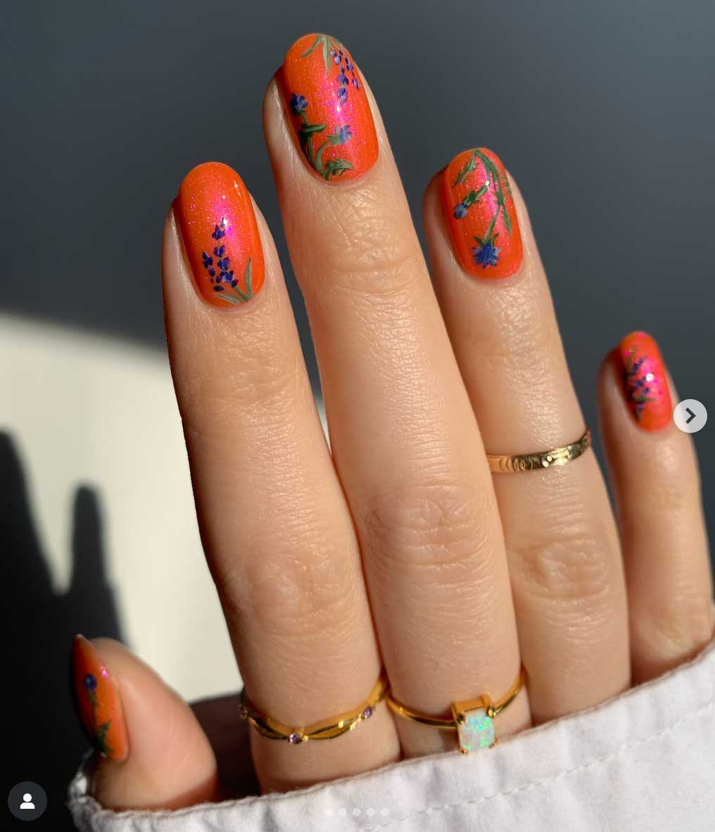 glittery orange nails with simple design