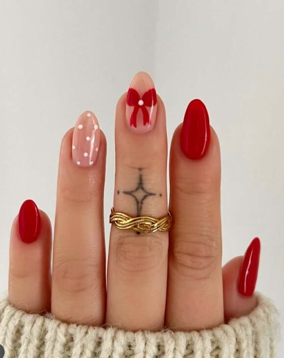 cute almond christmas nail art with red bow and white polka dot