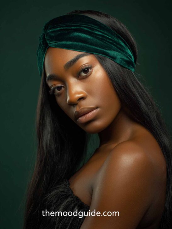 african woman with long dark hair down with elegant christmas hairstyle and headband