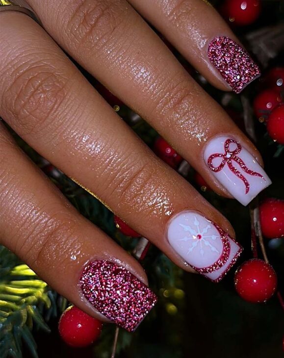 aesthetic glittery red bows and snowflake nail design for christmas festive and aesthetic manicure