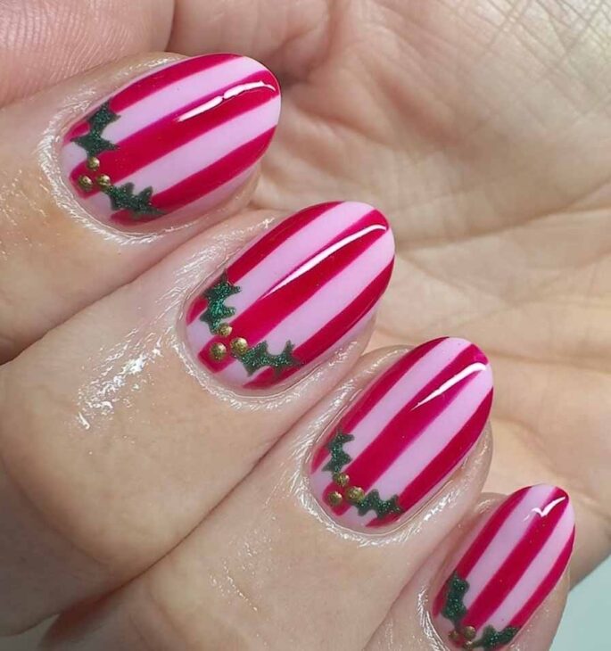 striped pink and red nails with cute holly design